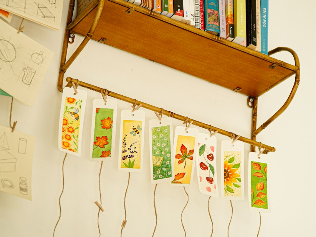 Books with ribbon bookmarks on a shelf
